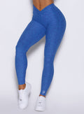 close up front view of a model wearing the Curvemax leggings in neon blue rave color 