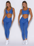 front view of a model showcasing the hide-able ties side by side wearing the Curvemax leggings in neon blue rave color 