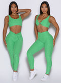 front profile view of a model showcasing the V cut and straight waistband side by side wearing the Curvemax leggings in neon miami beach color 