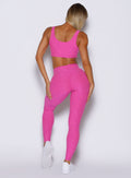 back profile view of a model wearing the Curvemax leggings in neon pink sorbet color