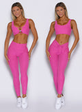 front profile view of a model showcasing the straight and V cut waistband side by side wearing the Curvemax leggings in neon pink sorbet color