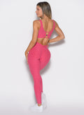 back profile view of a model wearing the Curvemax leggings in petal kiss color