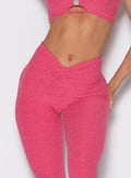 close up front profile view of a model with one hand on her thighs wearing the Curvemax leggings in petal kiss color