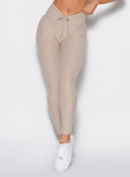 front profile view of a model wearing the Curvemax leggings in Taupe color