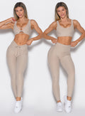 front profile view of a model wearing the Curvemax leggings in Taupe color  showcasing the adjusted and non-adjusted version of the waistband side by side