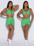 front view of a model showcasing the straight and V waistband on the Curvemax shorts in neon miami beach color