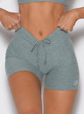 close up front profile view of a model wearing the Curvemax Shorts in sea moss color