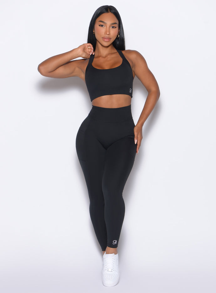 Front profile view of our model wearing the Curves Leggings in Black color