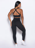 Back profile view of our model wearing the Curves Leggings in Black color