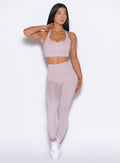 front profile view of our model looking to the left wearing the Curves 2.0 Leggings in Violet Ice color