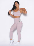front profile view of our model wearing the Curves 2.0 Leggings in Violet Ice color paired with the matching top