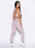 right side profile view of our model looking over her shoulder wearing the Curves 2.0 Leggings in Violet Ice color