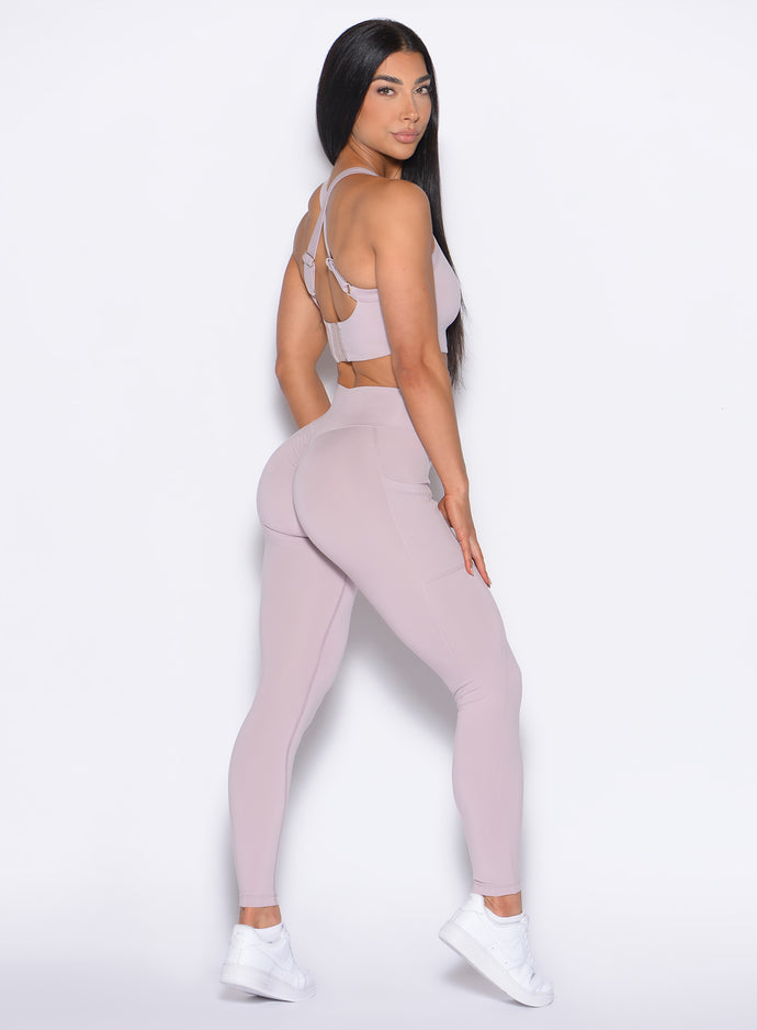 right side profile view of our model looking over her shoulder wearing the Curves 2.0 Leggings in Violet Ice color
