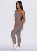 left side profile view of a model wearing our curves leggings in london fog color along with the matching bra