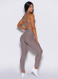 right side profile view of a model wearing our curves leggings in london fog color along with the matching bra