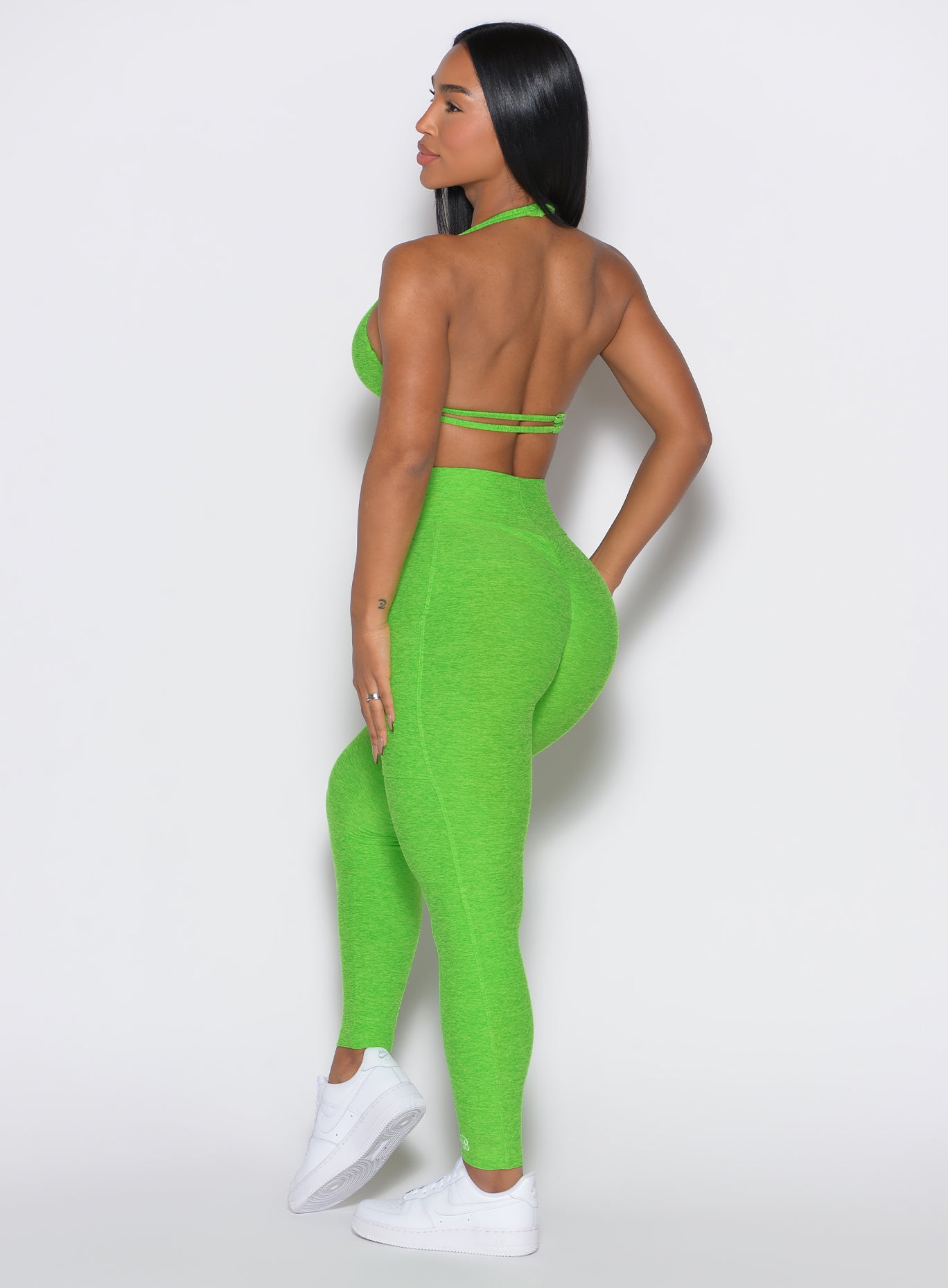 Sculpting Neon Lime Green Curves Leggings with side pockets for high-performance gym training.