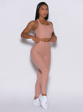 right side profile view of a model angled slightly to her right wearing our Curves leggings in Nude Sand color, paired with the matching sports bra.