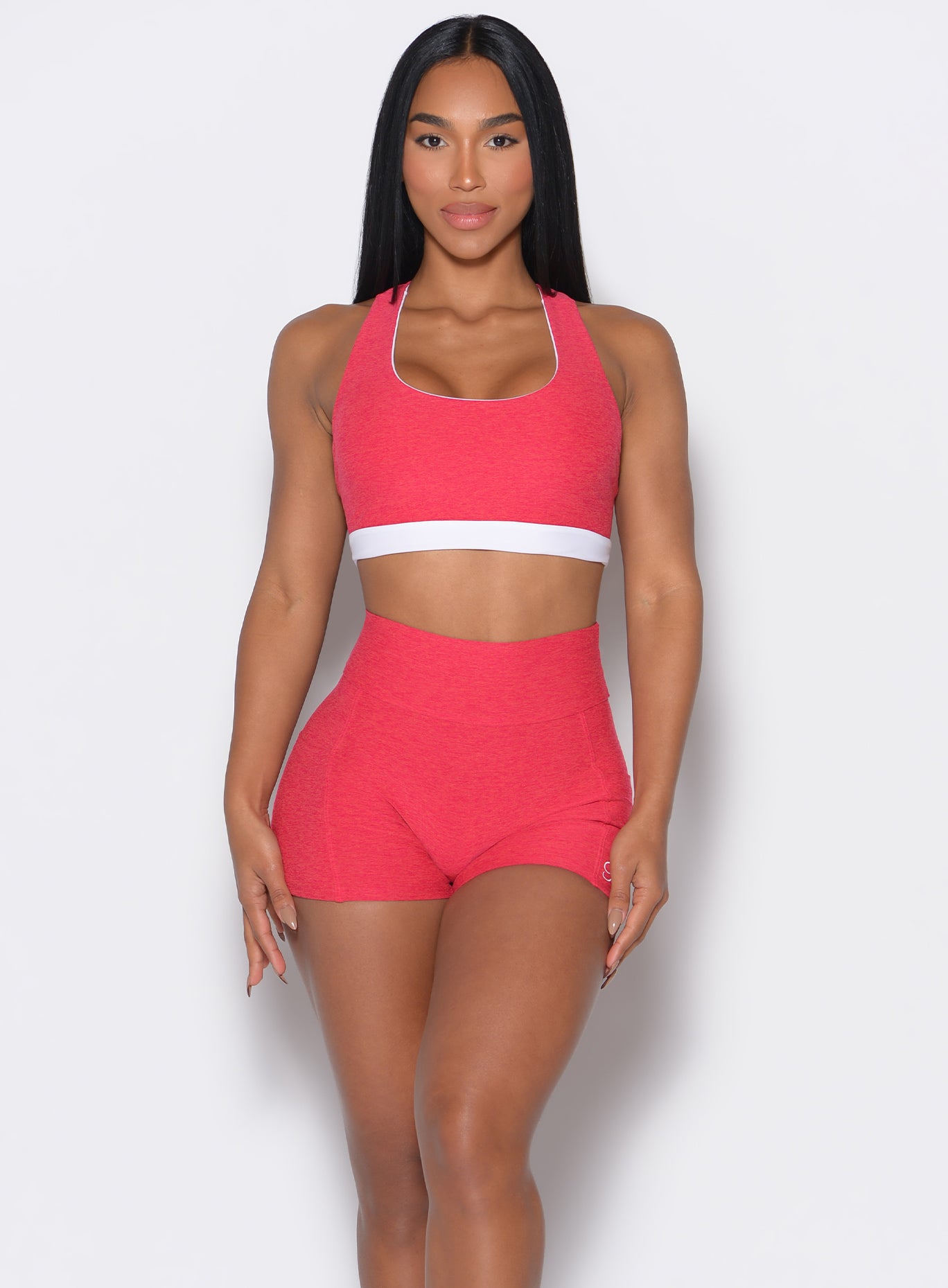 model facing forward wearing a reversible tank bra in raspberry punch color along with a matching shorts