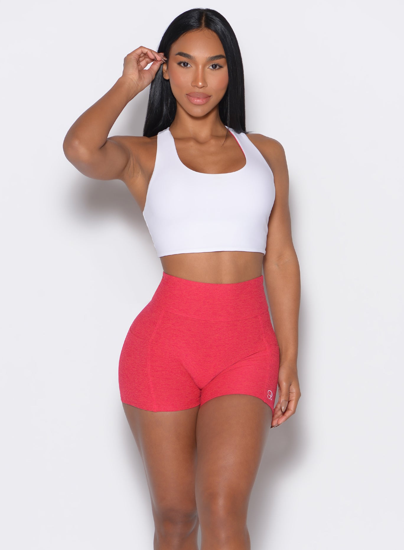 front profile view of a model wearing a reversible tank bra in white color along with a matching shorts