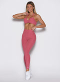 front profile view of a model wearing the Define Leggings in primrose color paired with the matching bra