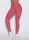 close up front left side profile view of a model wearing the Define Leggings in primrose color