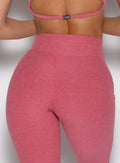 zoomed in back profile view of a model wearing the Define Leggings in primrose color