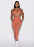 front profile view of a model wearing the Define Leggings in Spiced Maple color