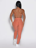 back profile view of a model wearing the Define Leggings in Spiced Maple color