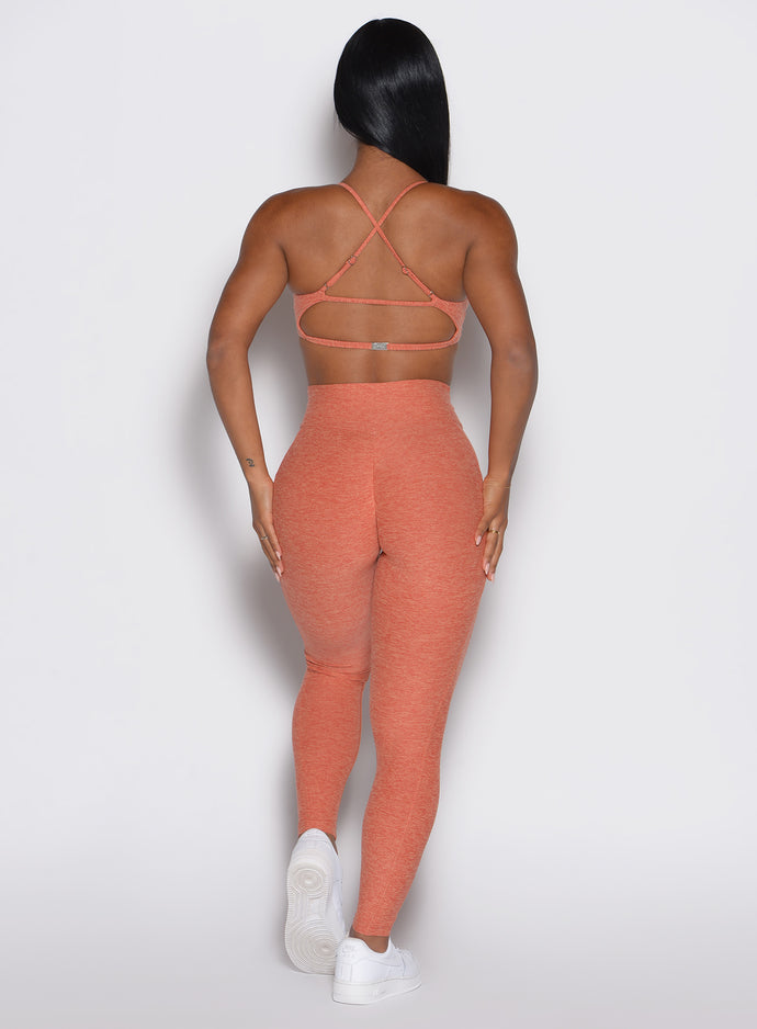 back profile view of a model wearing the Define Leggings in Spiced Maple color