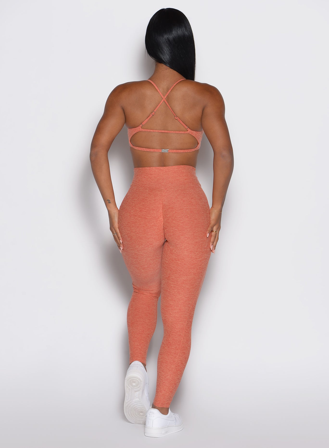 back profile view of a model wearing the Define Leggings in Spiced Maple color