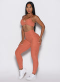 front left side profile view of a model wearing the Define Leggings in Spiced Maple color