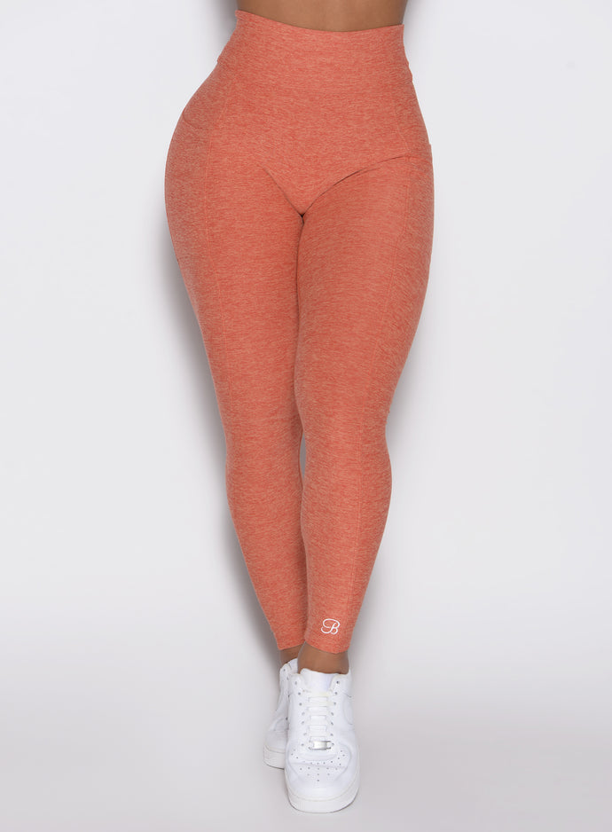 close up front view of a model wearing the Define Leggings in Spiced Maple color