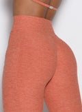 zoomed in back profile view of a model wearing the Define Leggings in Spiced Maple color