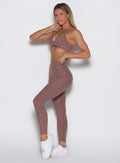 front left side profile view of a model wearing the Define Leggings in walnut color