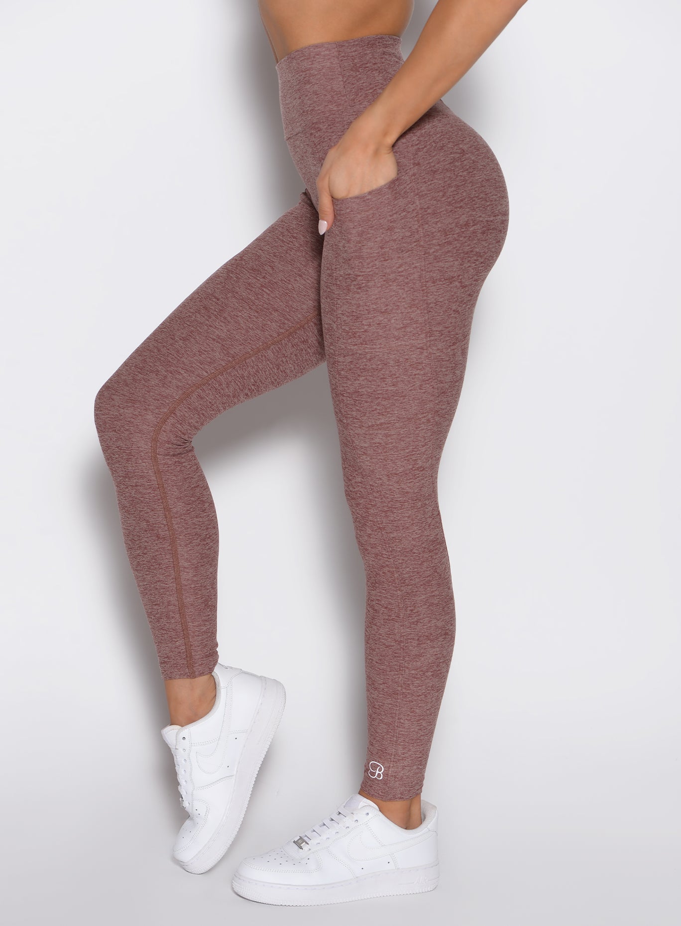 right side profile view of a model wearing the Define Leggings in walnut color