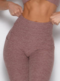 zoomed in front view of a model wearing the Define Leggings in walnut color