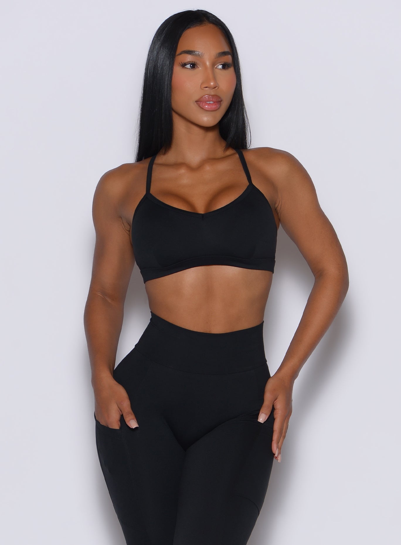 Front profile of a model wearing our black diamond sports bra and a matching leggings 