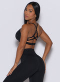 Left side profile of a model wearing our black diamond sports bra along with a matching leggings