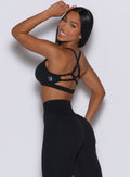 Left side profile of a model wearing our black diamond sports bra and a matching leggings