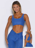 front profile view of a model wearing the Dualmode Bra in neon blue rave color  with the plain side in front and the B logo on the back