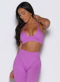 frontal view of a model wearing the Electric Era Bra in Purple rain color