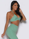 right side profile view of a model wearing the Electric Era Bra in Sage color