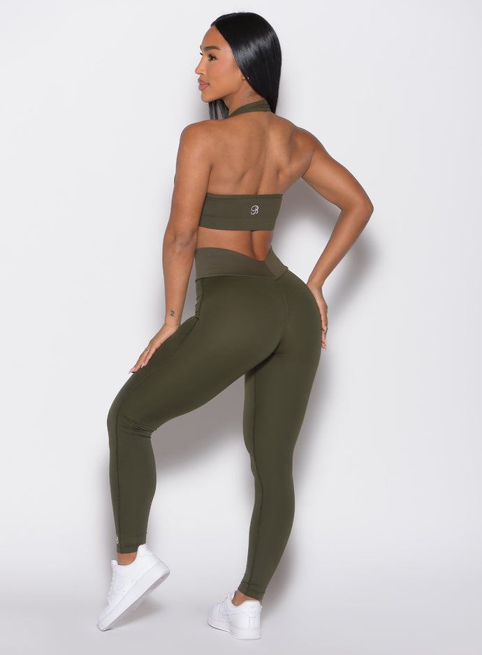 back profile view of a model wearing the Figure Butt Lift Leggings in forest night color