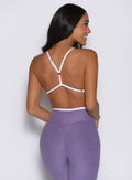 back profile view of a model facing to the right side wearing the Finish Line Bra in Violet color