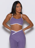 front profile view of a model facing to the left side wearing the Finish Line Bra in Violet color