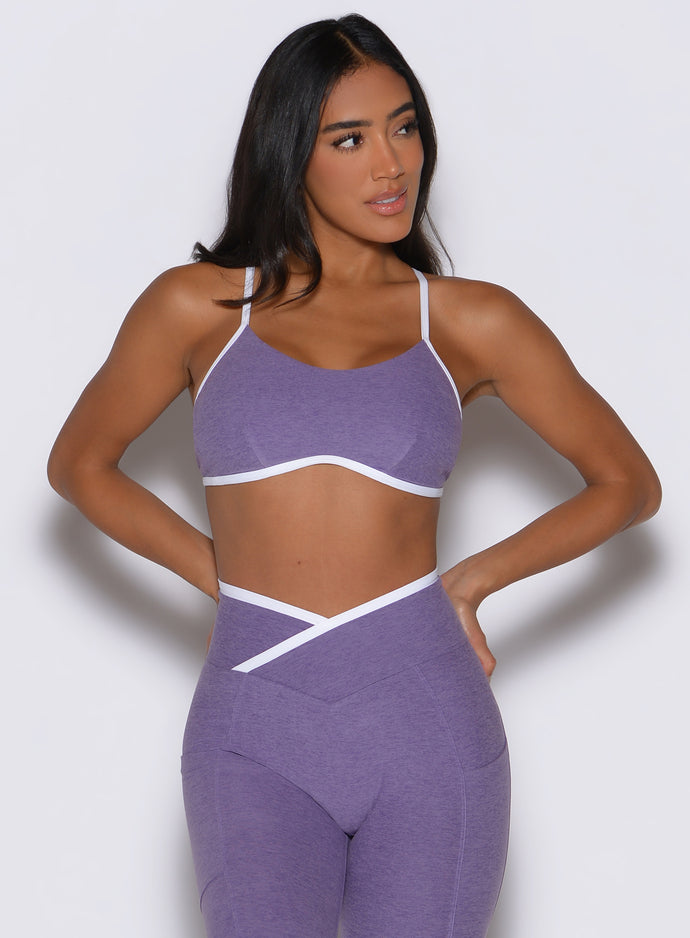 front profile view of a model facing to the left side wearing the Finish Line Bra in Violet color