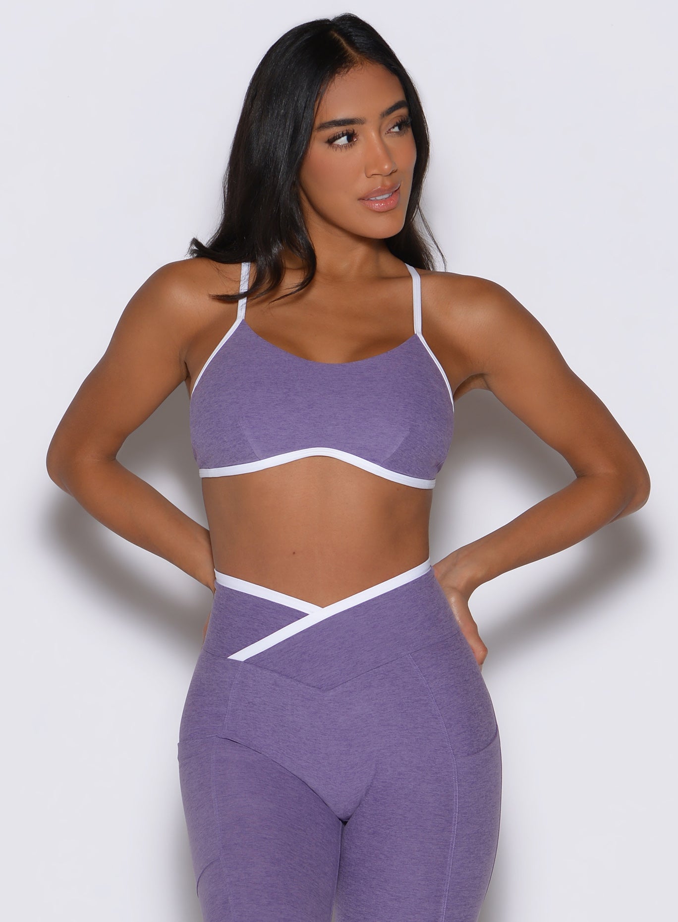 front profile view of a model facing to the left side wearing the Finish Line Bra in Violet color