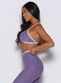 left side profile view of a model wearing the Finish Line Bra in Violet color