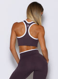 back profile view of a model wearing the  Finish Line Tank in black orchid color