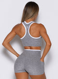 Back view of a Cloud white Finish Line Tank with a racerback and matching sculpting gym shorts.